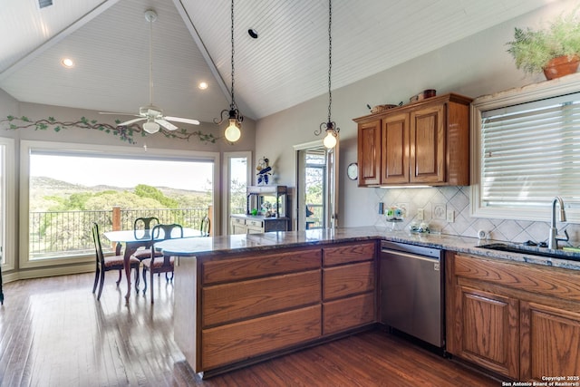 100W Tapatio Dr, Boerne, TX 78006 - kitchen with stainless steel dishwasher, dark wood finished floors, a peninsula, a sink, and brown cabinets