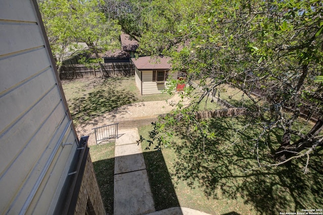 view of yard featuring an outbuilding and a fenced backyard