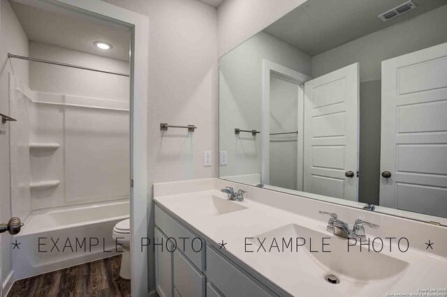 4731 Sahara Vlys, San Antonio, TX 78222 - full bath with toilet, wood finished floors, a sink, and visible vents