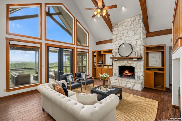 living area featuring a fireplace, a ceiling fan, high vaulted ceiling, and french doors