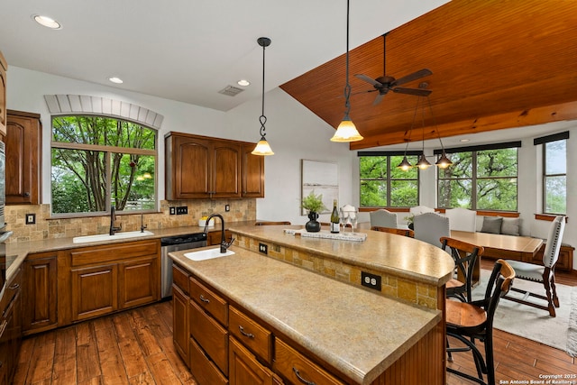 kitchen featuring dark wood-style floors, a sink, and a healthy amount of sunlight