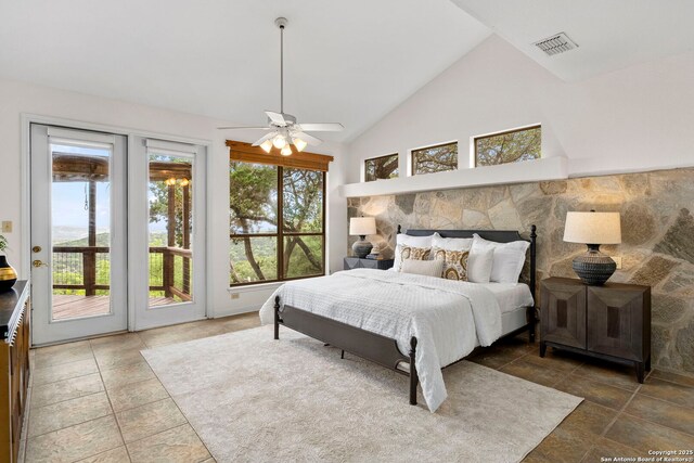 bedroom featuring vaulted ceiling, visible vents, and access to exterior