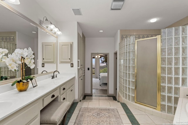 bathroom featuring a shower stall, tile patterned flooring, double vanity, visible vents, and a sink