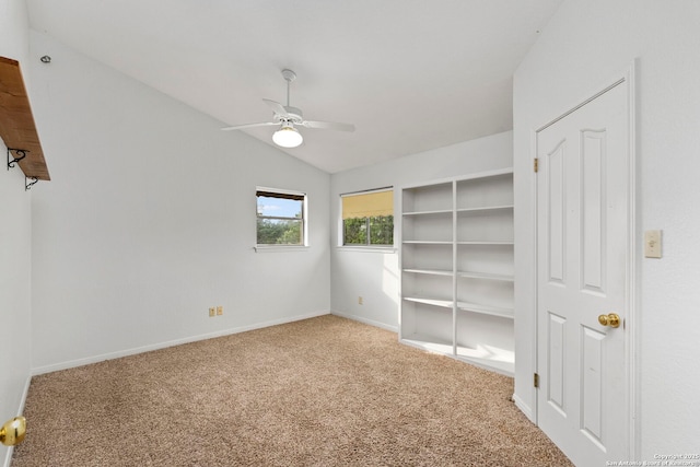 unfurnished bedroom with ceiling fan, carpet floors, lofted ceiling, and baseboards