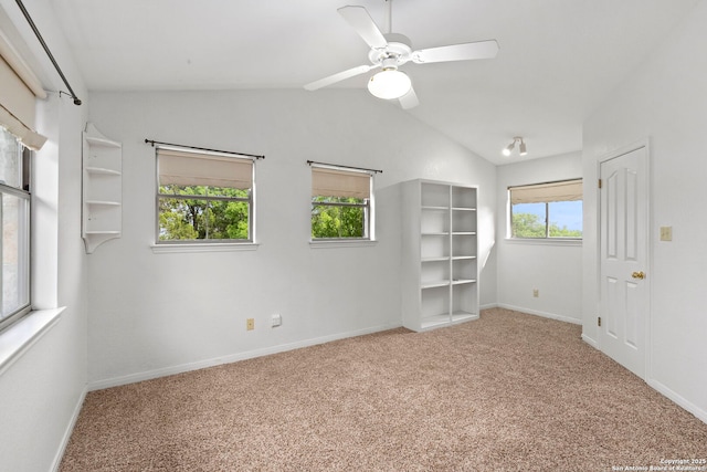 spare room with lofted ceiling, baseboards, carpet, and ceiling fan