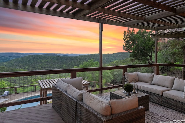 wooden terrace with a pergola, outdoor lounge area, and a mountain view