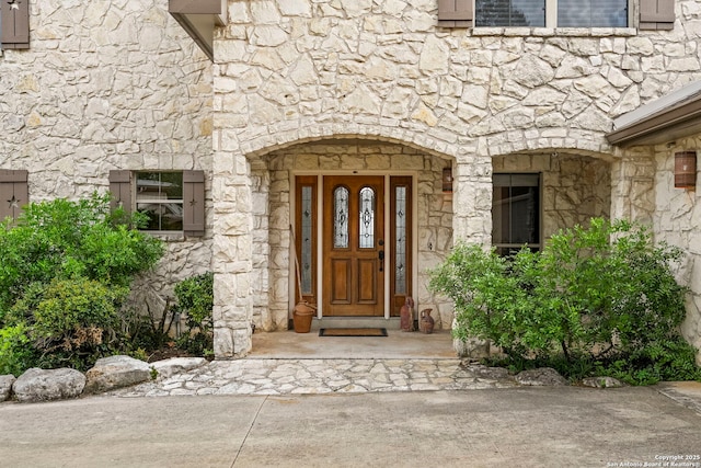 property entrance with stone siding