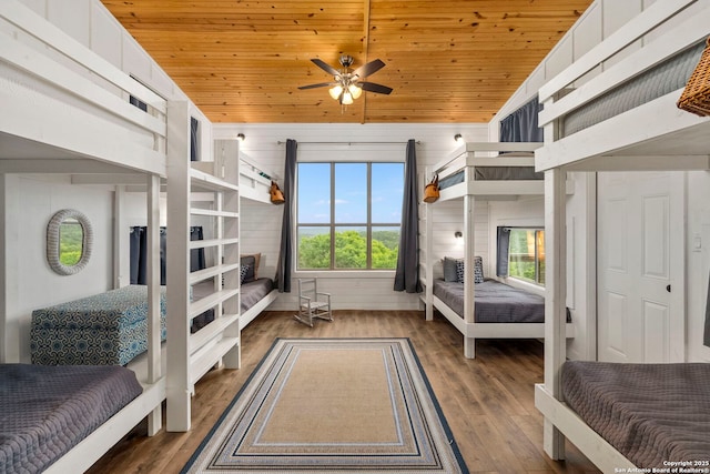 bedroom featuring wood ceiling, wood finished floors, and wood walls
