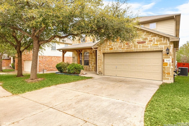 view of front facade featuring central AC, stone siding, a garage, concrete driveway, and a front lawn