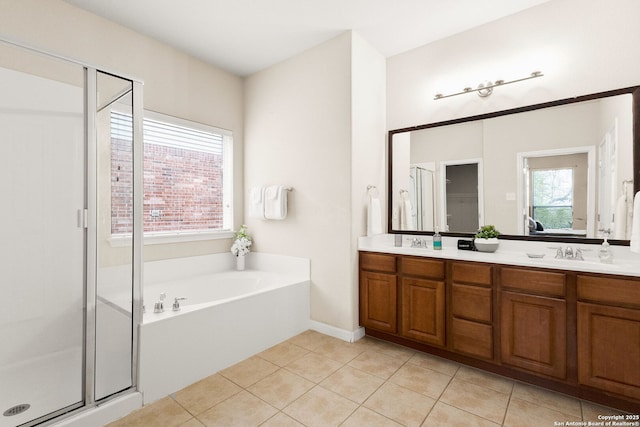 bathroom with a sink, double vanity, a stall shower, tile patterned flooring, and a garden tub