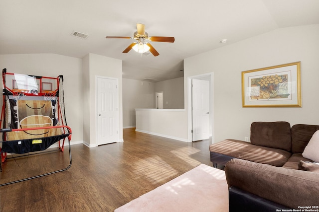 living area featuring a ceiling fan, wood finished floors, vaulted ceiling, and visible vents