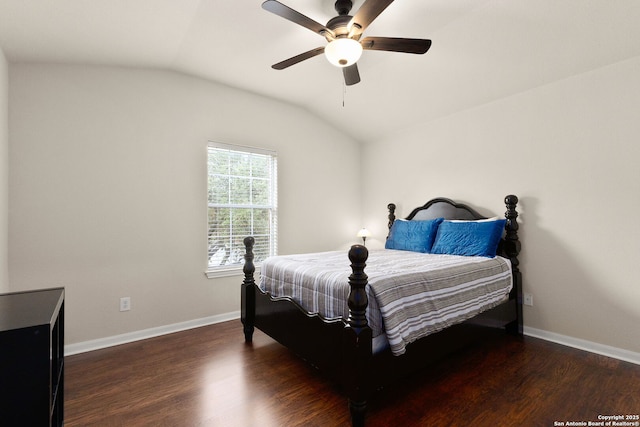 bedroom featuring baseboards, wood finished floors, vaulted ceiling, and a ceiling fan