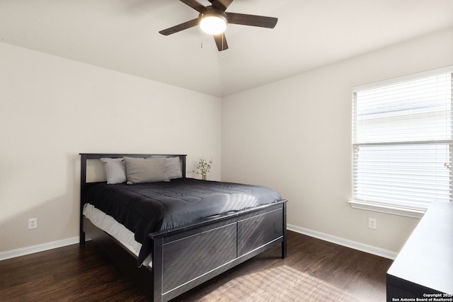 bedroom with ceiling fan, baseboards, vaulted ceiling, and wood finished floors