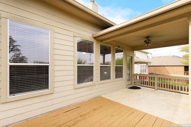 wooden deck featuring ceiling fan