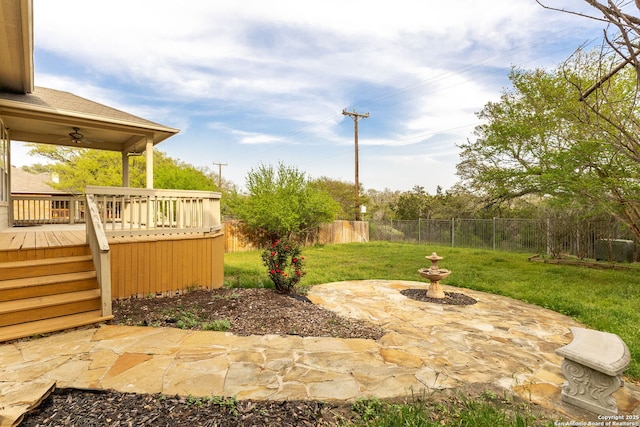 view of yard with a patio area, a fenced backyard, and ceiling fan