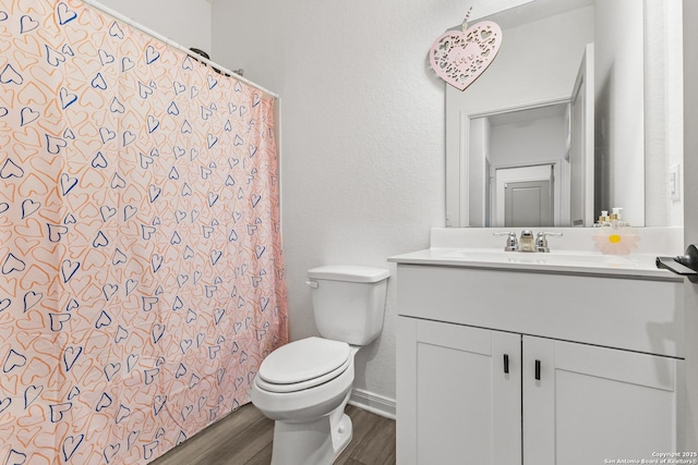 7415 Cheetah Pass, San Antonio, TX 78253 - bathroom featuring vanity, a shower with curtain, toilet, wood finished floors, and baseboards