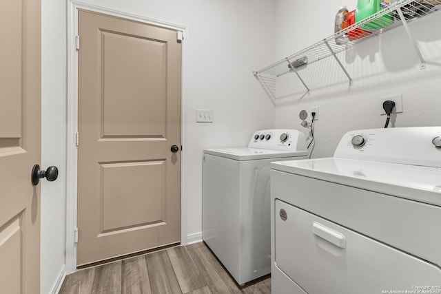 7415 Cheetah Pass, San Antonio, TX 78253 - laundry area with light wood-style flooring, washer and clothes dryer, laundry area, and baseboards