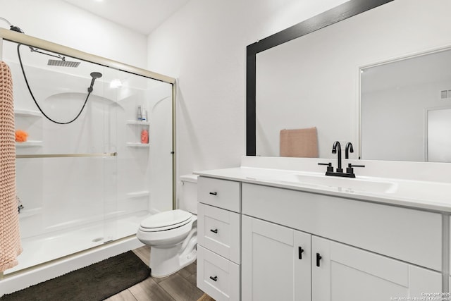 7415 Cheetah Pass, San Antonio, TX 78253 - full bathroom with a shower stall, wood finished floors, vanity, and toilet