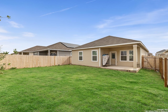 7415 Cheetah Pass, San Antonio, TX 78253 - back of house featuring a patio, a fenced backyard, roof with shingles, and a lawn