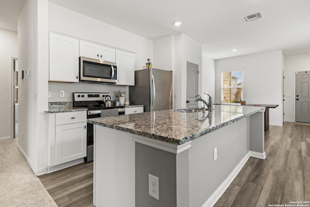 7415 Cheetah Pass, San Antonio, TX 78253 - kitchen featuring visible vents, white cabinets, a sink, appliances with stainless steel finishes, and dark stone counters