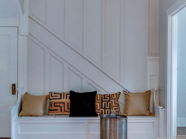 mudroom featuring a decorative wall