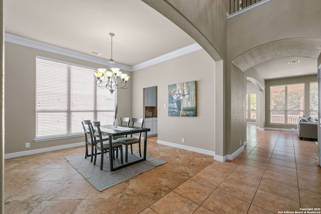 dining room featuring baseboards, an inviting chandelier, crown molding, visible vents, and arched walkways