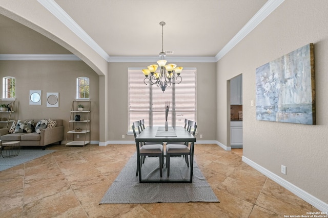 dining space with a chandelier, arched walkways, baseboards, and crown molding