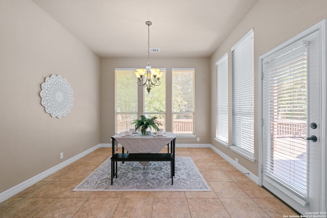 home office with a healthy amount of sunlight, an inviting chandelier, baseboards, and light tile patterned floors