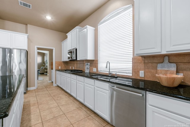 kitchen with light tile patterned floors, white cabinetry, visible vents, appliances with stainless steel finishes, and a sink