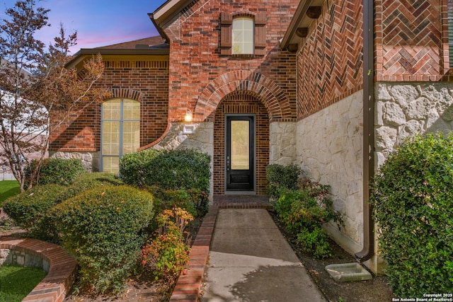 entrance to property with brick siding