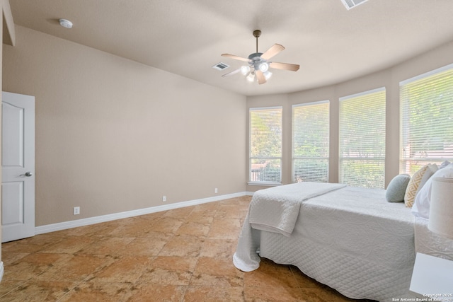 bedroom featuring visible vents, multiple windows, baseboards, and ceiling fan