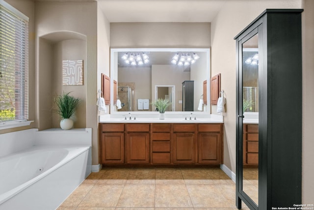 full bath featuring double vanity, a bath, a sink, and a stall shower