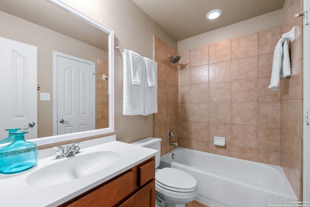 bathroom with washtub / shower combination, toilet, and vanity