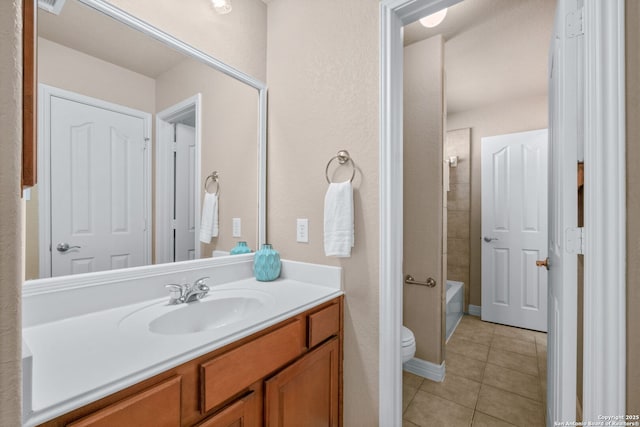 bathroom with tile patterned flooring, vanity, and toilet