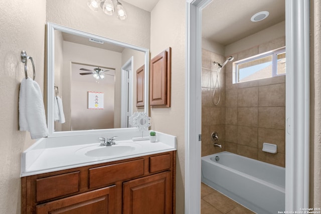 bathroom featuring vanity, shower / washtub combination, a textured wall, tile patterned flooring, and a ceiling fan