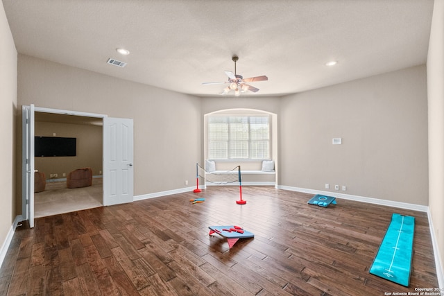 workout room with wood finished floors, ceiling fan, baseboards, and recessed lighting