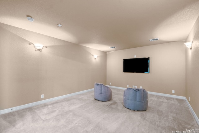 cinema with visible vents, baseboards, and light carpet