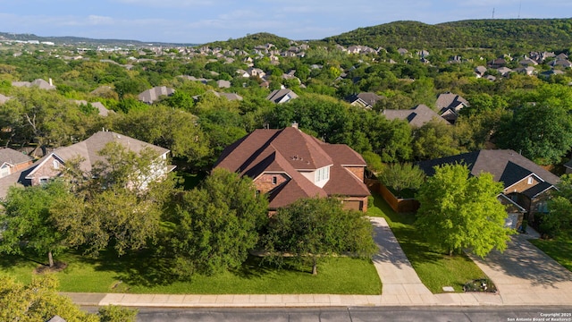 birds eye view of property with a mountain view and a residential view