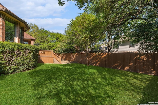 view of yard with a wooden deck and fence