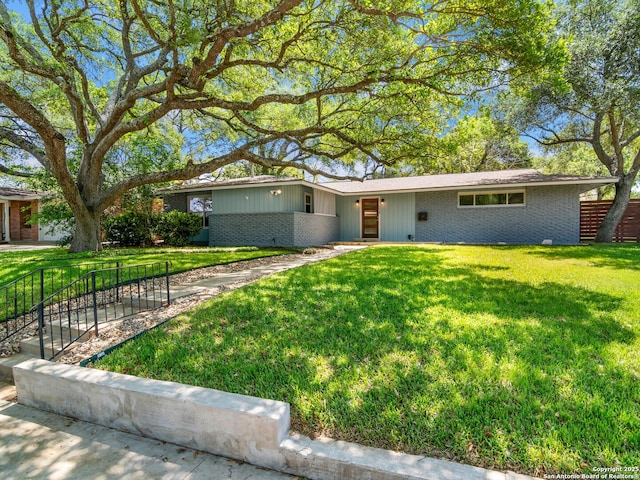 ranch-style house with brick siding and a front lawn