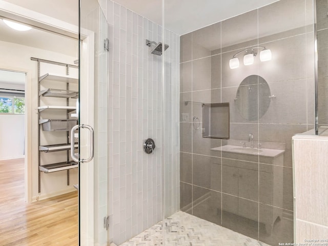 bathroom featuring a stall shower and wood finished floors
