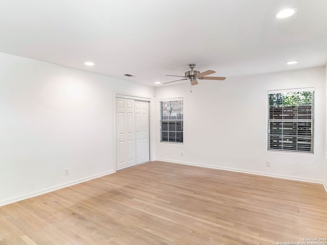 spare room with recessed lighting, light wood finished floors, baseboards, and ceiling fan