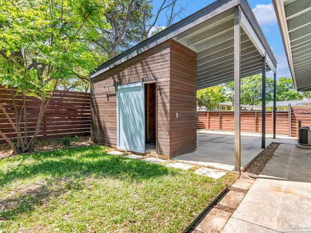 view of shed featuring fence