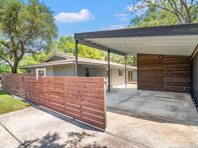 garage with an attached carport and driveway