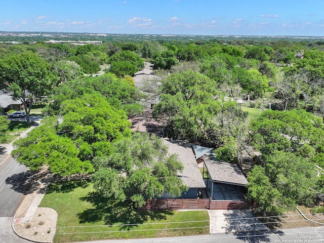 drone / aerial view featuring a wooded view