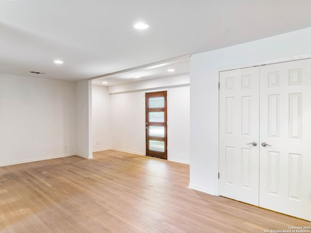interior space with light wood-style flooring, visible vents, and recessed lighting