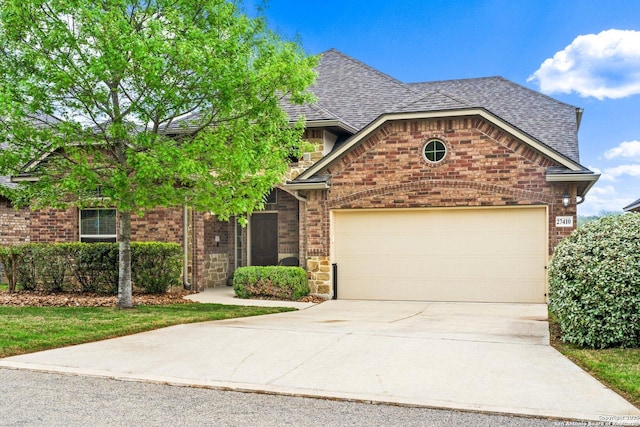 view of front of property featuring concrete driveway, roof with shingles, brick siding, and an attached garage