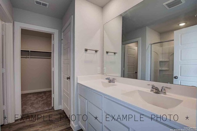 10638 Fairchild Way, San Antonio, TX 78109 - bathroom featuring double vanity, a sink, visible vents, and walk in shower