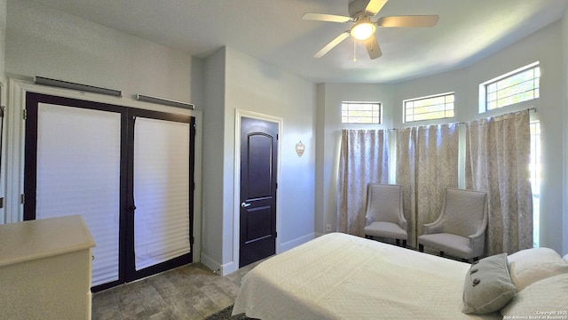 bedroom with wood finished floors, ceiling fan, and baseboards