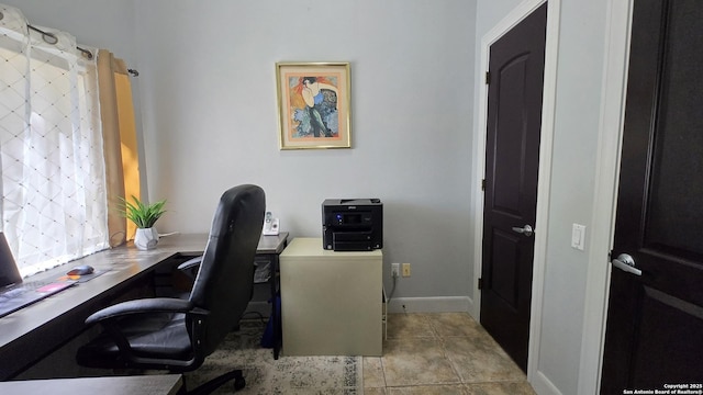 tiled office space featuring baseboards